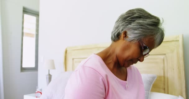 Senior woman reading book on bed — Stock Video