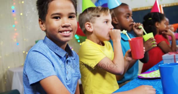 Boy sitting with friends during birthday party — Stock Video