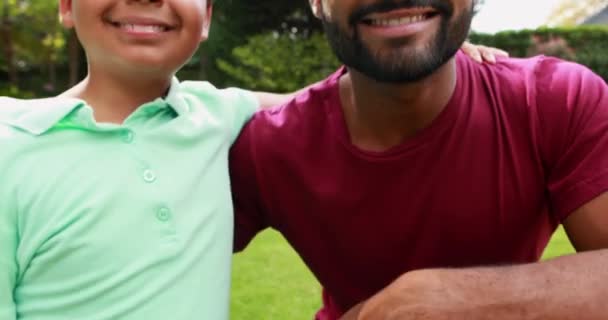 Father and son standing with arm around — Stock Video