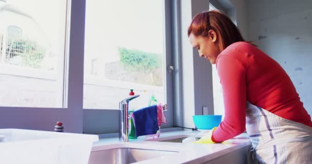Kvinna tvätta redskapen i diskbänk — Stockvideo