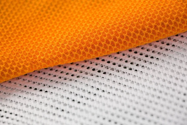 Close-up van witte en oranje textiel — Stockfoto