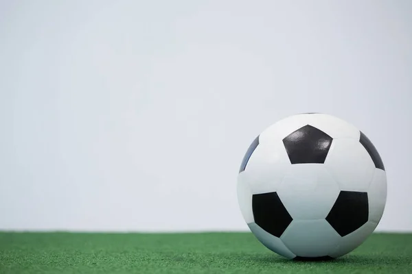 Football kept on artificial grass — Stock Photo, Image