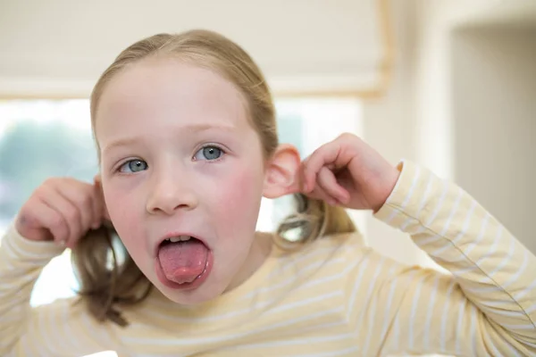Young girl making funny faces — Stock Photo, Image
