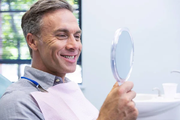 Smiling man looking in mirror — Stock Photo, Image