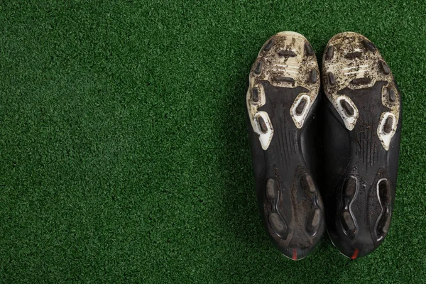 Cleats kept upside down on artificial grass — Stock Photo, Image