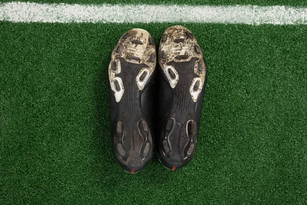 Cleats kept upside down on artificial grass — Stock Photo, Image