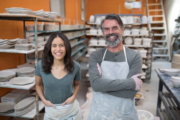 Мужчина и женщина-гончар стоят в мастерской по керамике — стоковое фото