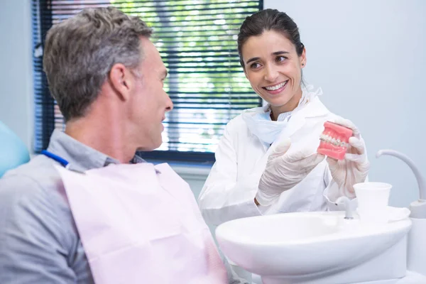 Zubař zobrazeno zubní plísní na člověka na klinice — Stock fotografie