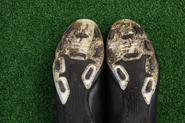 Cleats kept upside down on artificial grass — Stock Photo, Image