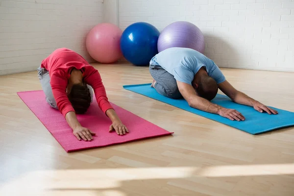 Instructor with student practicing child pose — Stock Photo, Image