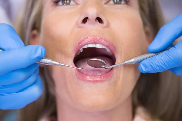 Dentista examinando paciente na clínica médica — Fotografia de Stock