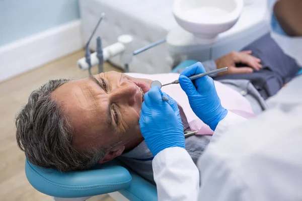 Dentist examining senior man — Stock Photo, Image