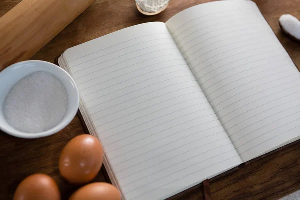 Livro, ovos, farinha e rolo — Fotografia de Stock