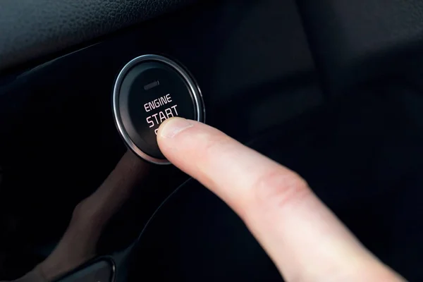 Finger pressing start button in car — Stock Photo, Image