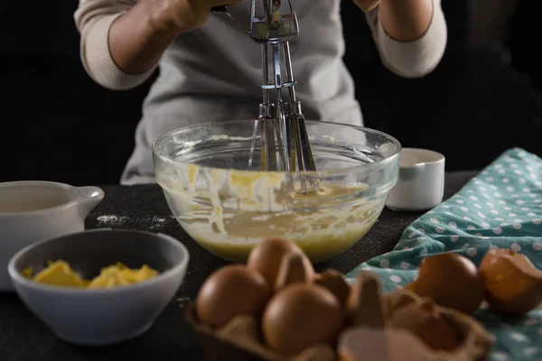Woman whisking batter in a bowl — Stock Photo, Image