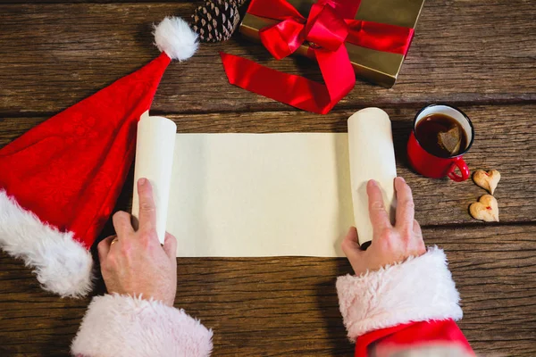 Santa Claus opening blank scroll