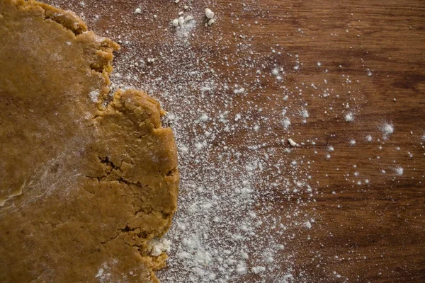 Flattened dough on a wooden table — Stock Photo, Image