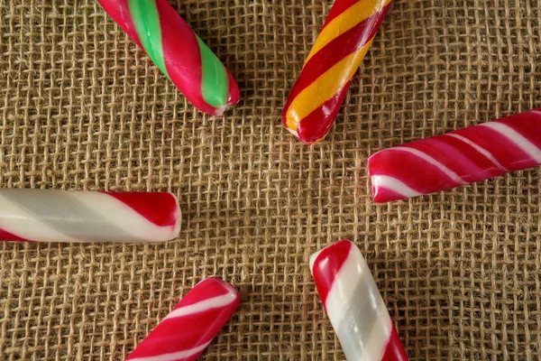 Multicolored candy canes arranged on fabric — Stock Photo, Image