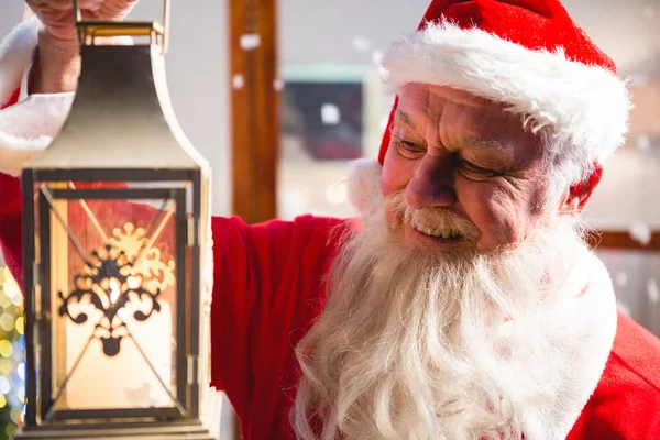 Santa Claus holding Christmas lantern — Stock Photo, Image