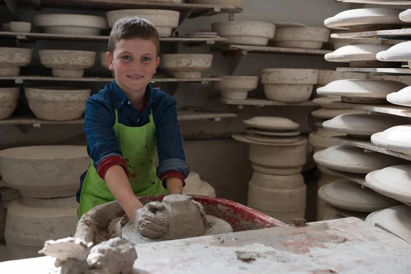 Мальчик делает горшок в мастерской керамики — стоковое фото