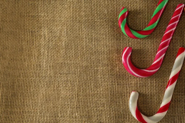 Multicolored candy canes arranged on fabric — Stock Photo, Image