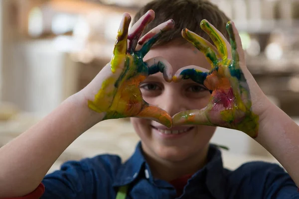 Boy gesturing with painted hands — Stock Photo, Image