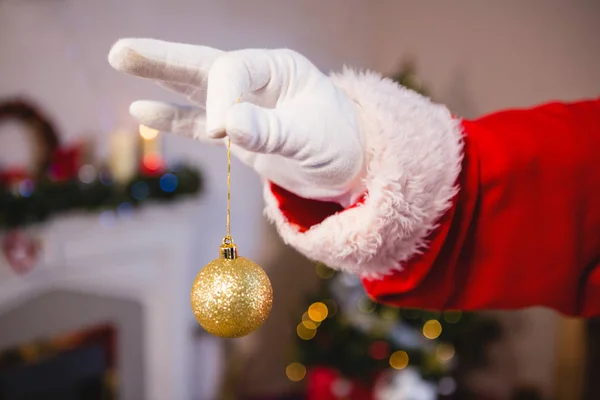 Santa claus holding a bauble — Stock Photo, Image