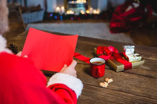 Papá Noel sosteniendo papel rojo en blanco — Foto de Stock