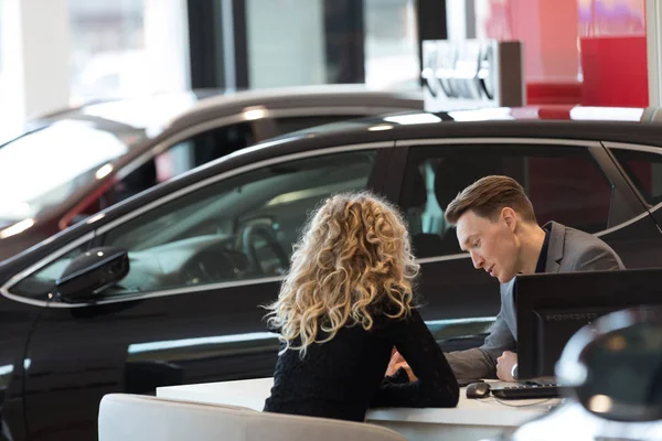 Bil försäljare diskuterar med kunden — Stockfoto