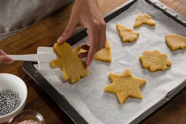 Homem colocando biscoitos de gengibre na assadeira — Fotografia de Stock