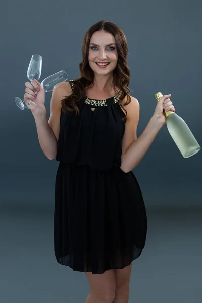 Woman holding champagne bottle — Stock Photo, Image