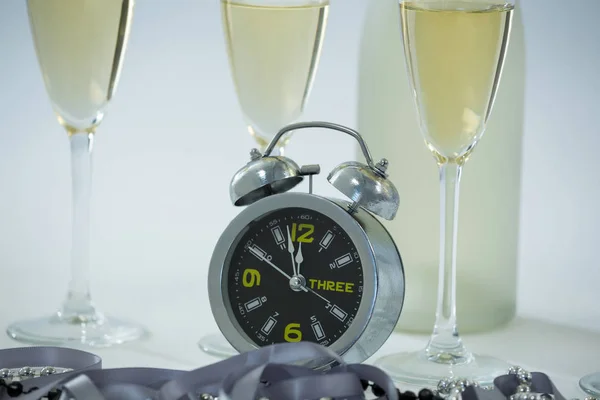 Champagne with alarm clock and glass — Stock Photo, Image