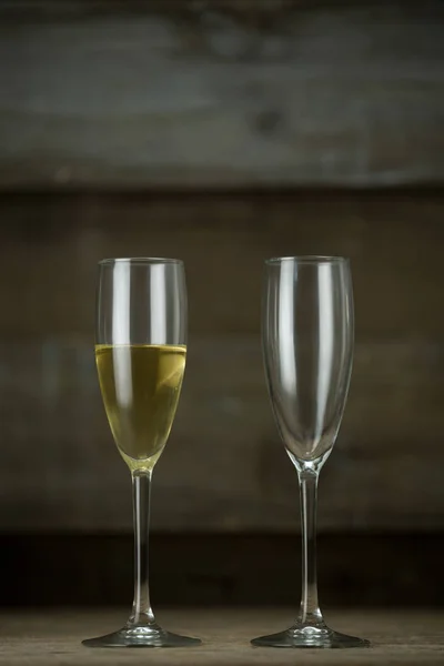 Full and empty glass of champagne — Stock Photo, Image