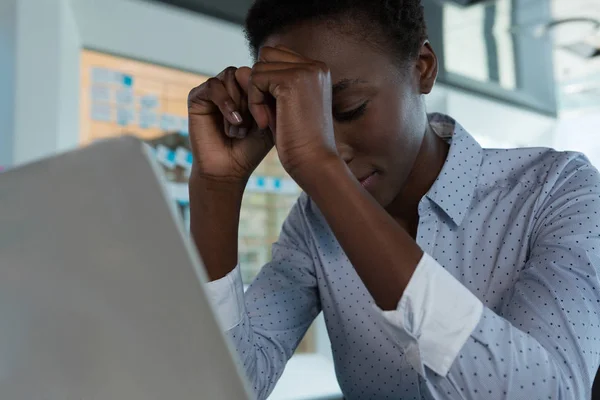 Female executive sitting in futuristic office — Stock Photo, Image