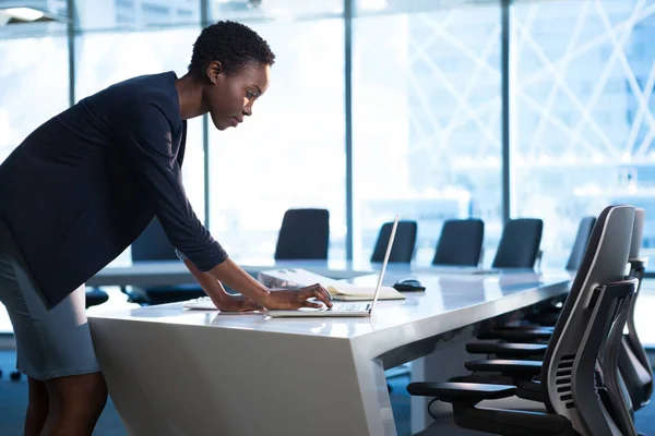 Female executive using laptop at table — Stock Photo, Image