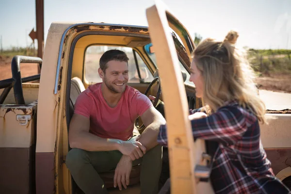 Couple interacting with each other near a car — Stock Photo, Image