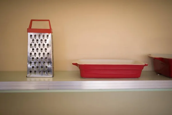 Grater and tray in the shelf — Stock Photo, Image