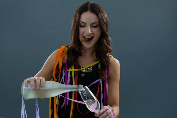 Woman pouring champagne into glass — Stock Photo, Image