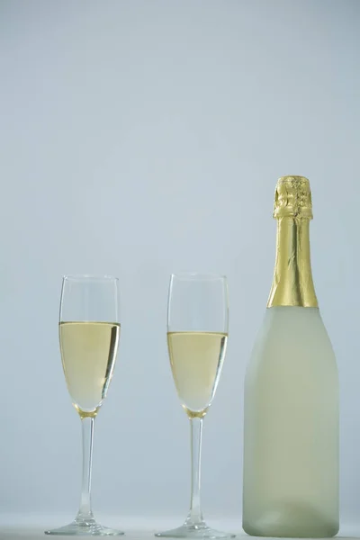 Glass of champagne with champagne bottle Stock Picture