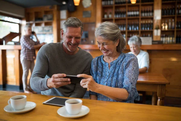 Senior couple looking their photos — Stock Photo, Image