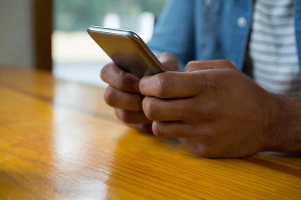 Uomo che utilizza il telefono cellulare in caffè — Foto Stock