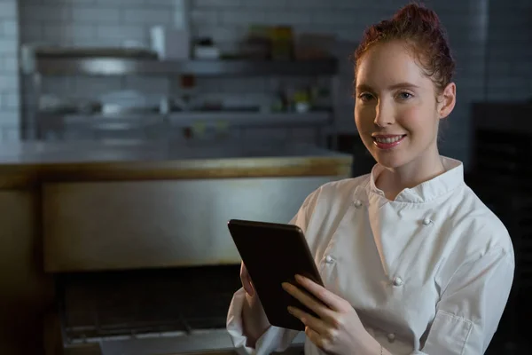 Female chef using tablet