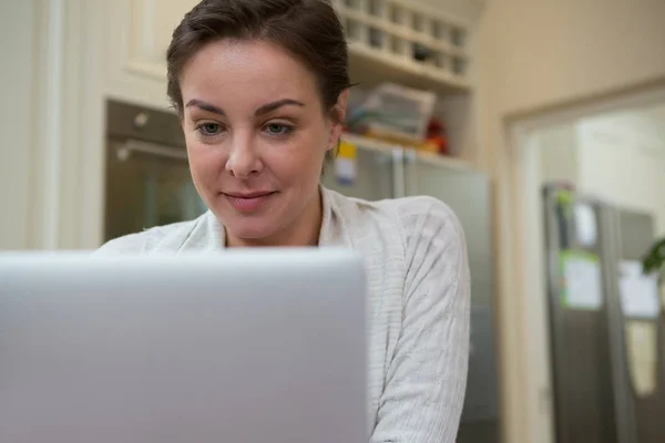 Laptopot használó nő a konyhában — Stock Fotó