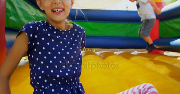 Kids playing on the bouncing castle — Stock Video