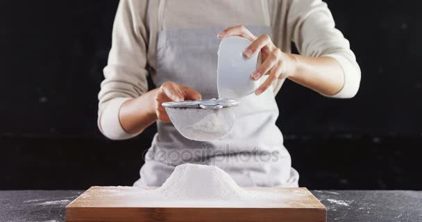 Woman sieving flour from the bowl — Stock Video