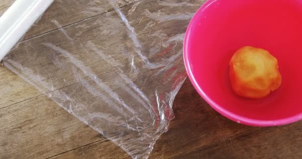 Dough ball in bowl with wrapping paper — Stock video