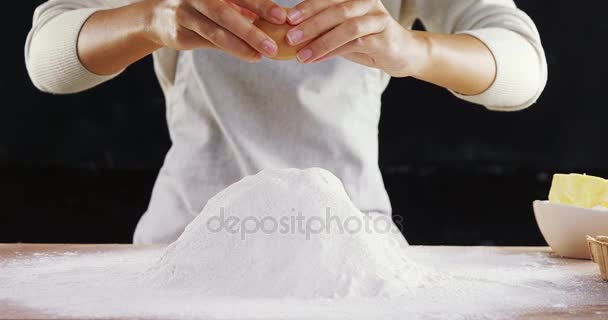 Woman adding egg white into flour — Stock Video