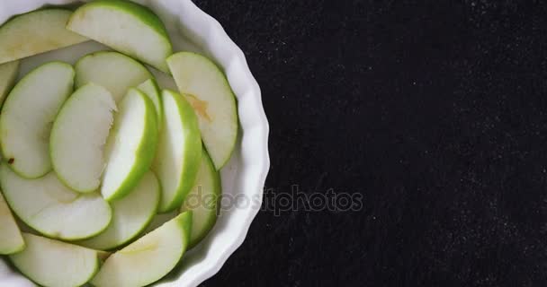 Slice of green apple on bowl — Stock Video