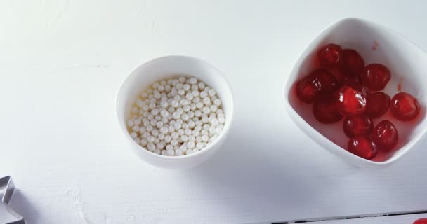 Red cherries in bowl with star shape cutter — Stock Video