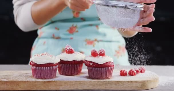 Woman icing sugar powder on on cupcakes — Stock Video